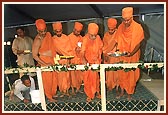 After laying the stones Swamishri sprinkles water, flowers, kumkum and rice grains as part of the rituals