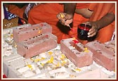 Performing Vedic pujan of the stones to be laid in the foundation with kumkum, flowers and panchamrut