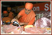 Performing Vedic pujan of the stones to be laid in the foundation with kumkum, flowers and panchamrut