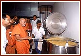 Swamishri stirring the 'daal' during his visit to the mandir kitchen