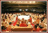 Dignitaries and devotees participate in the maha-puja rituals