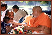 Blessing and initiating a baby boy into Satsang