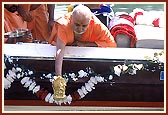 After worshiping Shri Ganeshji, Swamishri ritually places Ganeshji in the water 