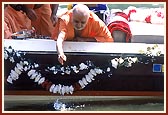After worshiping Shri Ganeshji, Swamishri ritually places Ganeshji in the water 
