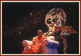 Amidst a beautiful backdrop of the universe, Swamishri blesses the assembly