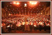 Devotees perform arti during the assembly