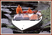 Swamishri offers two sanctified flowers into the lake and a prayer for the salvation of all living things in the lake 