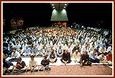 Devotees seated for the evening assembly