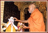 Swamishri performing the murti pratishtha ceremony