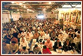 Devotees seated in the murti pratishtha assembly