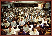 Devotees join in the singing of the arti