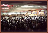Devotees seated in the assembly