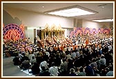 Swamishri joined by devotees in performing the Annakut arti in the Haveli hall   