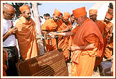 Sprinkling holy water on the Akshardham stone plaque