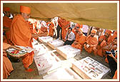 Observing and showering flowers on the nine carved stones to be placed in the foundation
pit