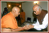 Shri L. K. Advani, Home Minister of India, offers his respects and a pot of holy water from the River Sindhu