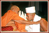 Swamishri gives the diksha mantra while initiating Yogen Patel of London (Svetketu Bhagat) into parshad-fold