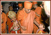 Swamishri blesses a costumed child who had welcomed him