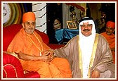 Mr. Mummad Nur Sultan with Swamishri after presenting a rosary