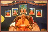 Swamishri performs arti during maha-puja (peace prayer)