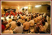 Devotees performs arti in maha-puja