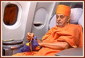 Engrossed in bhajan during the flight to Muscat