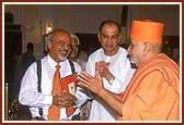 Swamishri with Shri Kanakshi Khimji (center) and Shri Kiran Ashar