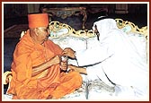 The Sheikh holds the incense as a mark of respect