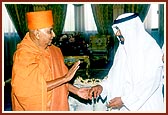 The Sheikh holds Swamishri's hand and sees him to the palace gate