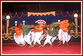 Tribal devotees perform a traditional tribal dance during the public assembly