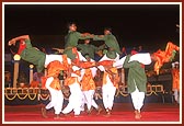 Tribal devotees perform a traditional tribal dance during the public assembly