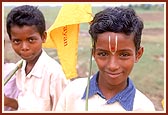 Udiya satsangi children wave the flags as a gesture of welcome