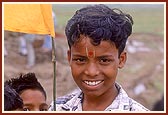 Udiya satsangi children wave the flags as a gesture of welcome