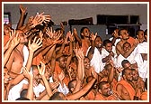 Swamishri also sprays color on the sadhus