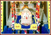 Thakorji in a hindolo decorated with pavitra on Pavitraa Ekadashi