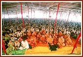 Sadhus and devotees listening to the discourse
