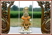Shri Harikrishna Maharaj swings on an automated ornate swing