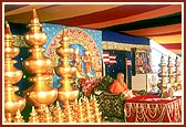 The golden kalashas, flag staffs and flags for the new shikharbaddh mandir placed on stage during Swamishri's puja