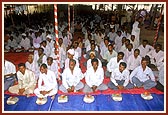 People engaged in the pujan of bricks for the BAPS reconstruction project of 17 schools destroyed by the earthquake
