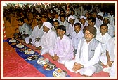 People engaged in the pujan of bricks for the BAPS reconstruction project of 17 schools destroyed by the earthquake