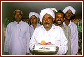 A representative of Bhadiyaad village holding a sanctified brick 