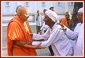 Swamishri blesses the same aged devotee who is delighted with Swamishri's care and love 