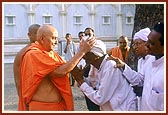 Swamishri blesses the same aged devotee who is delighted with Swamishri's care and love 