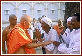 Swamishri blesses the same aged devotee who is delighted with Swamishri's care and love 