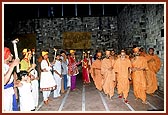 Swamishri was welcomed by youths with flaming torches and devotees in Yogi Smruti Mandir  