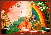 Swamishri chants the Swaminarayan mahamantra with a large painting of Gunatitanand Swami in the backdrop in consonance with Sharad Purnima festival