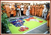 Swamishri blesses the youth who had done the rangoli on the Yogi Smruti Mandir compound