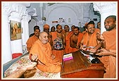 Swamishri sanctifies the mandir's office and serves penda to all sadhus