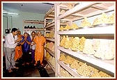 Swamishri blesses the devotees behind the Annakut preparations