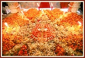 The shrine at Yogi Smruti Mandir decorated with flowers and candles